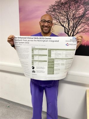 Leon holding up his ECS adults poster